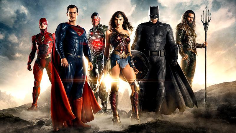 The DCEU Justice League standing with a sunset behind them
