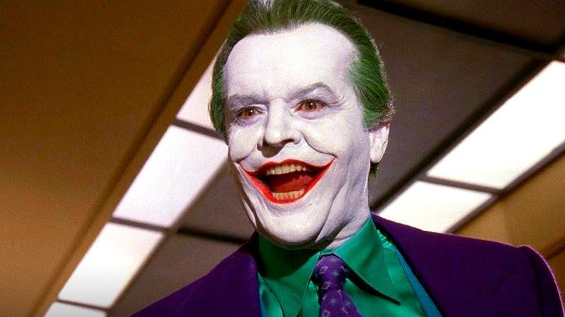 Jack Nicholson as Joker smiling in an office building in Batman