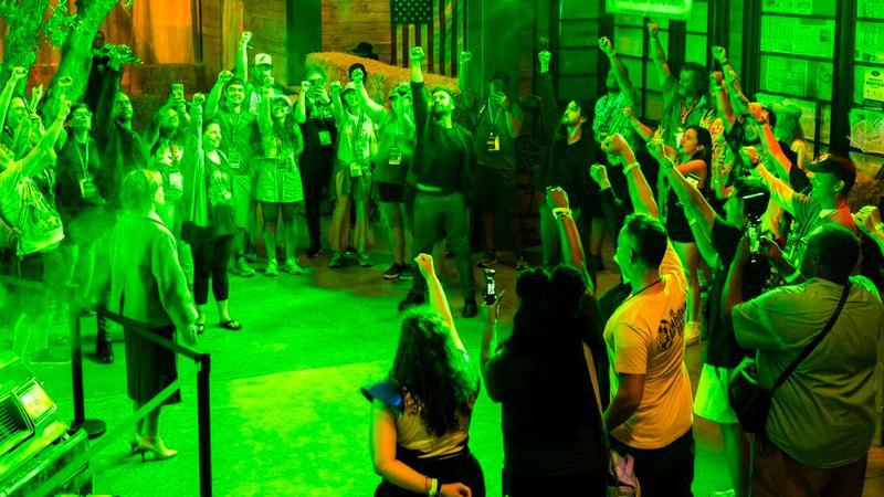 Fans reciting the Green Lantern oath and holding their fists in the air.