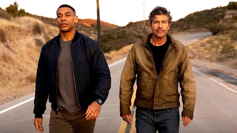 Aaron Pierre as John Stewart walking down a road next to Kyle Chandler as Hal Jordan in Lanterns