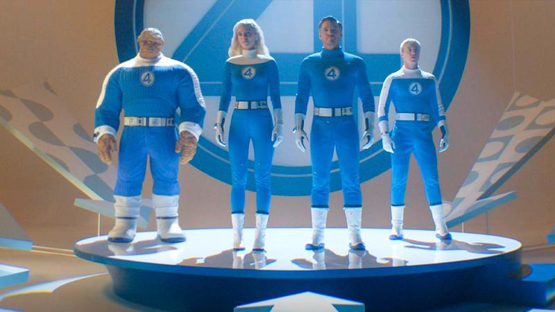 The cast of Fantastic Four: First Steps in full blue uniform standing on a platform