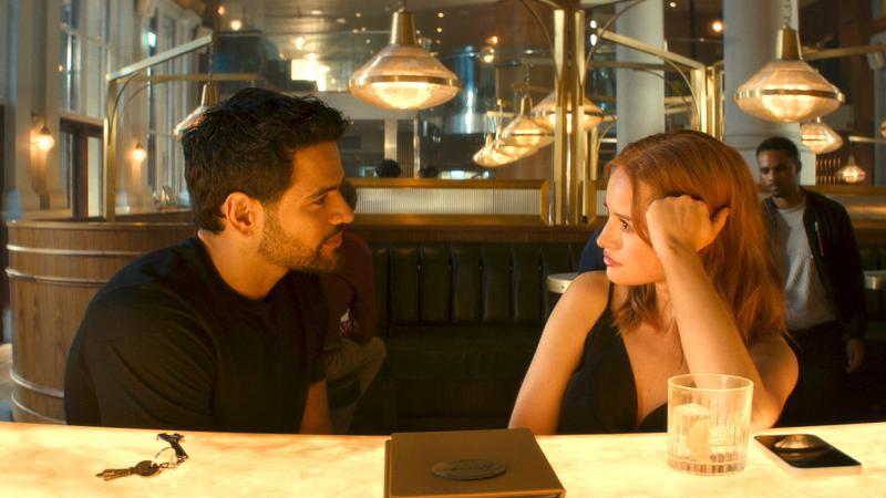 Madelaine Petsch and Jacob Scipio sitting at a table in Maintenance Required.