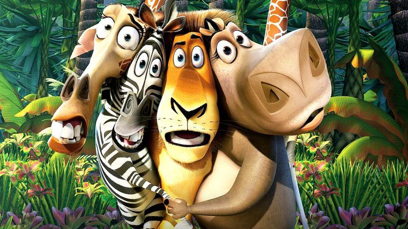 A giraffe, zebra, lion, and hippo in the jungle in Madagascar