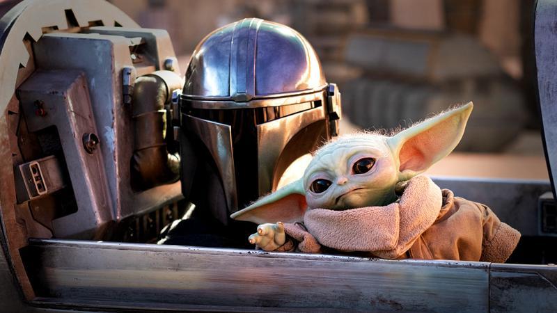 Mando and Grogu sitting in a speeder in The Mandalorian