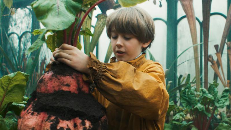 Neville Longbottom pulling plant in Herbology in HBO Harry Potter show.