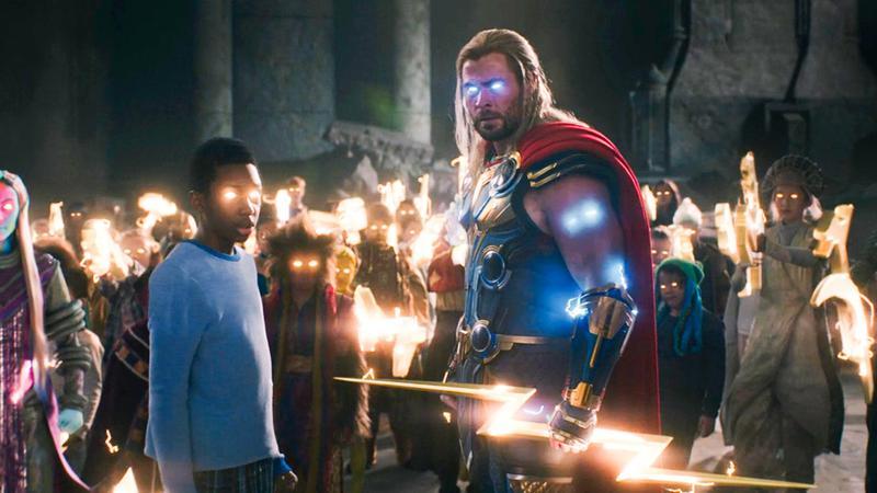 Thor with Asgardian kids with Thunderbolt in Thor Love and Thunder.