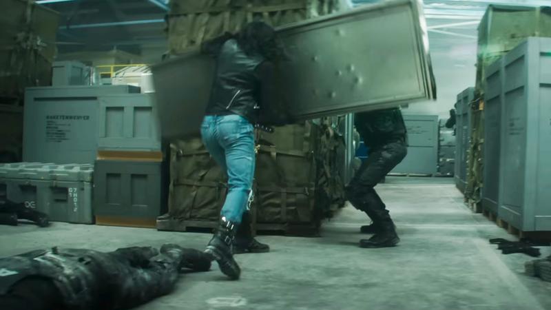 Krysten Ritter Jessica Jones fighting AVTF officers in warehouse.