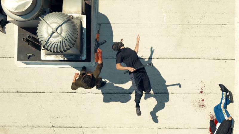 The Punisher killing bad guys on a roof.