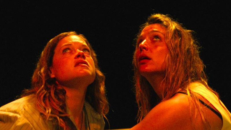 Jane Levy and Jessica Rothe staring into the sky in River.