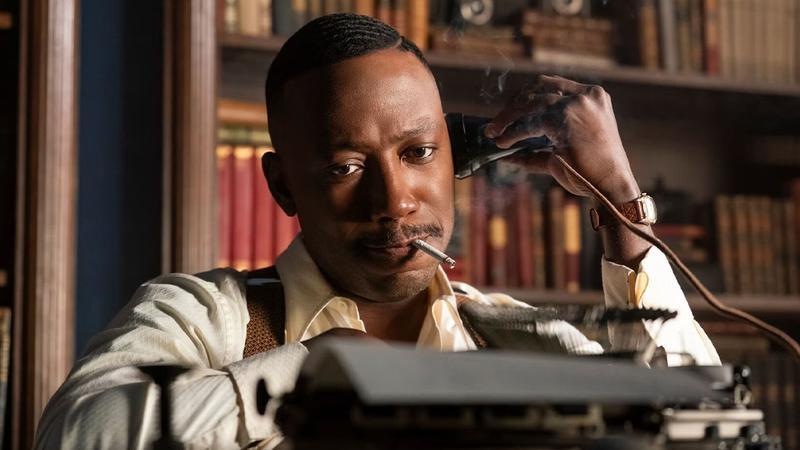 Lamorne Morris as Robbie Robertson at Typewriter in Spider-Noir.