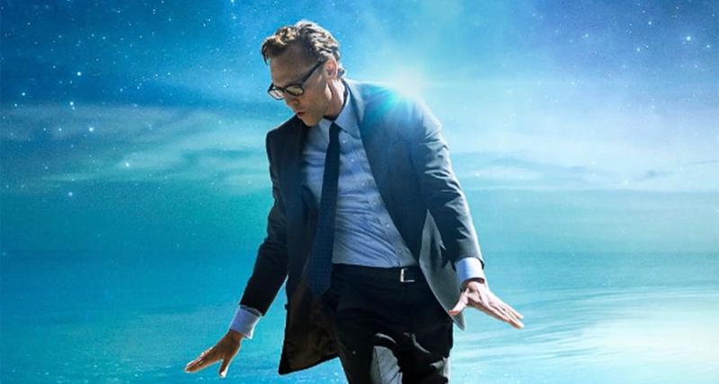 A man in a suit dances through water and clouds.