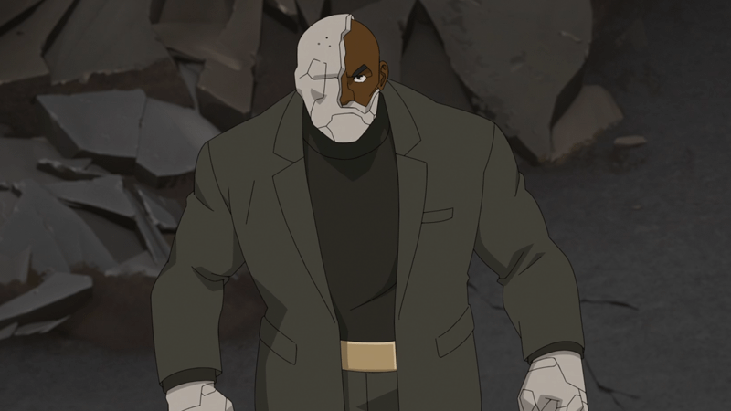 Titan in his suit with half his concrete face shell broken off.