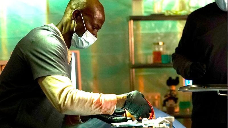 Djimon Hounsou as Dr. Keizan doing surgery in Twisted.