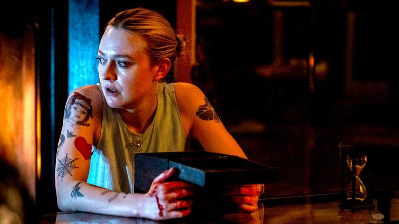 Dakota Fanning in Vicious holding a black box.