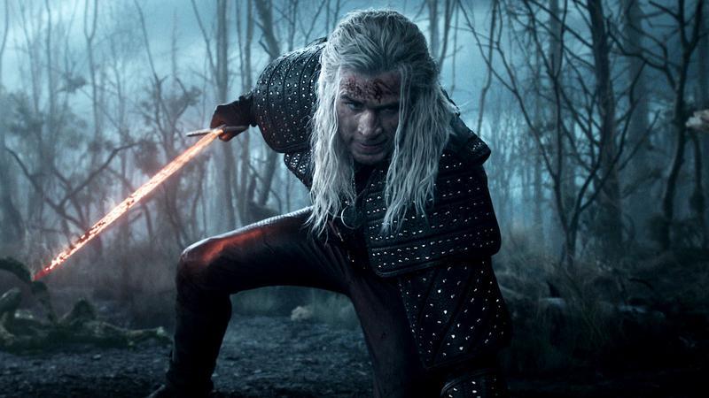 Liam Hemsworth as Geralt of Rivia with a burning sword in The Witcher
