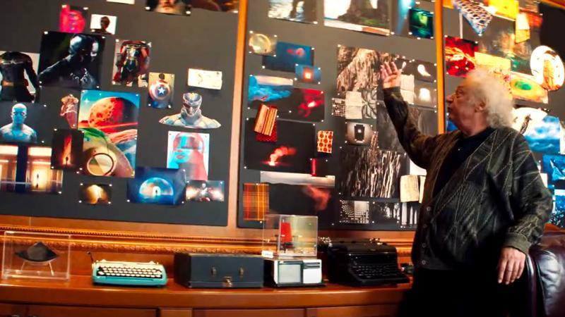 A man with pointing at a mood board in Wonder Man