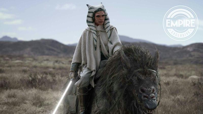 Ahsoka with her lightsaber riding an animal.