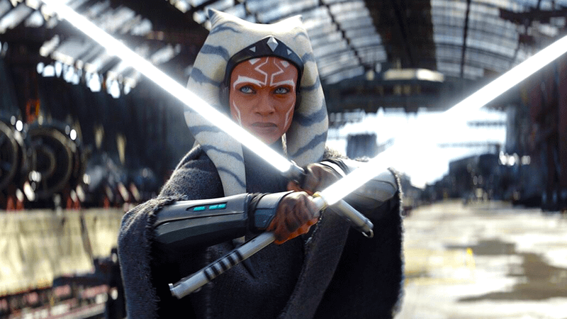 Rosario Dawson as Ahsoka Tano wielding her dual white-bladed sabers in Ahsoka Season 1.