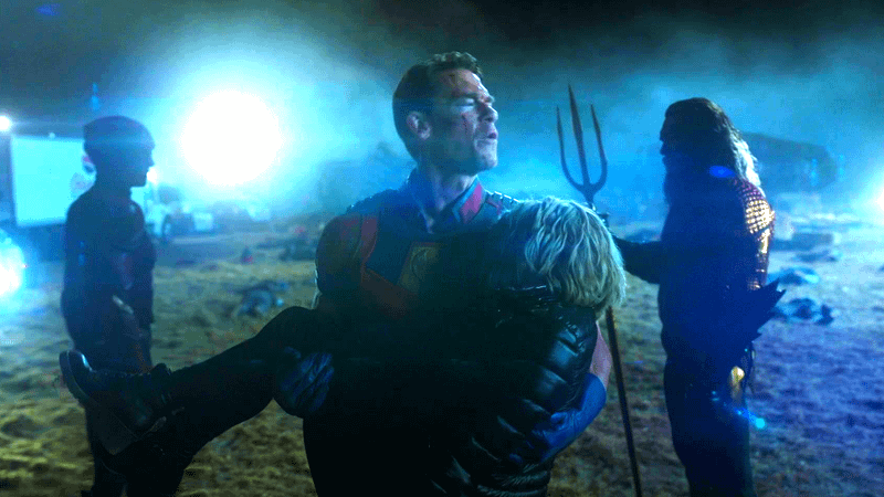 John Cena as Peacemaker walking past Aquaman and Flash in Peacemaker Season 1
