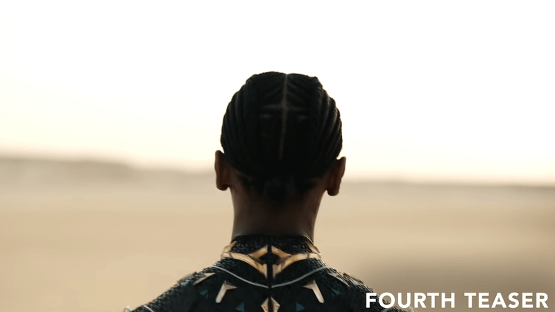 The back of Shuri's head approaching desert.
