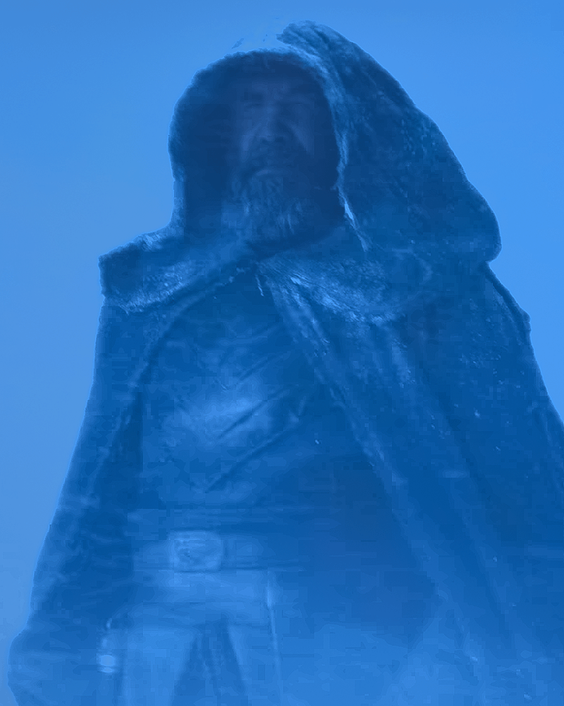 Rory McCann in a heavy hooded cloak.