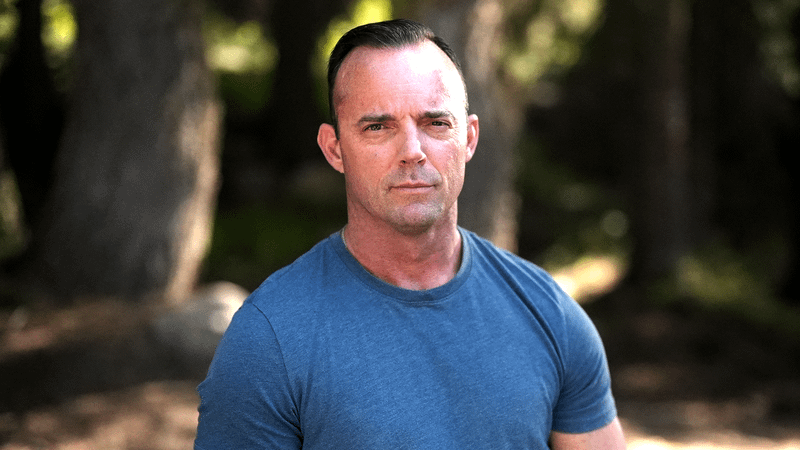 Robert Collier in a blue t-shirt in Bigfoot Took Her