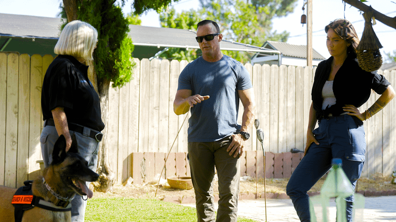 Jessica and Rob talking to a woman with a police dog in Bigfoot Took Her