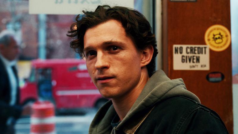 Peter Parker sitting in a cafe.