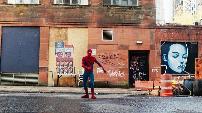 Spider-Man standing on the street.