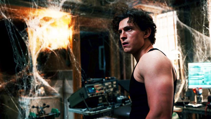 Peter Parker surrounded by webbing in his apartment.