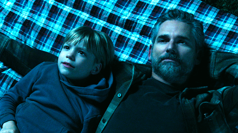 Eric Bana as Kyle Turner and Ezra Wilson as Caleb laying on a blanket in Untamed