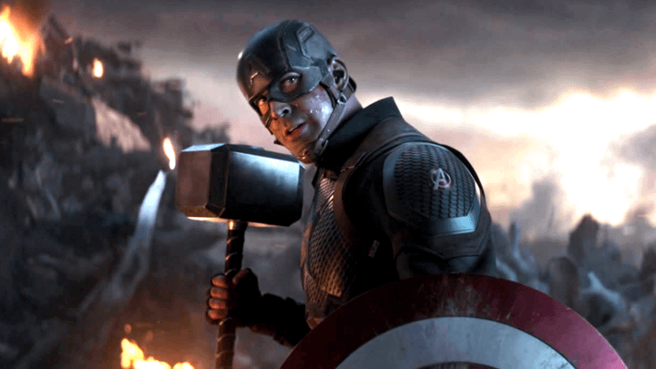 Steve Rogers holding Mjolnir and his shield.