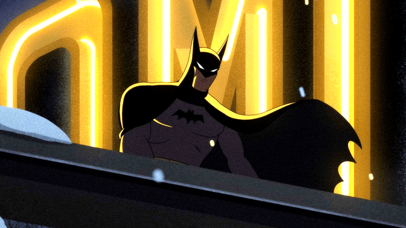 Batman with an ominous look as he stares down from a building.