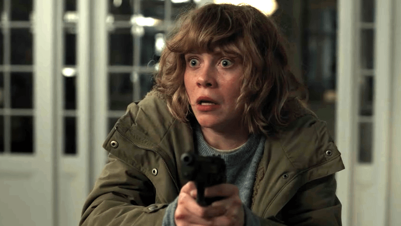Sophia Lillis as Carrie holding a gun in All Her Fault