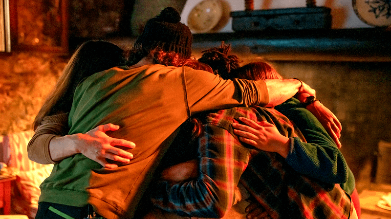  The climbers hugging each other in The Climb.