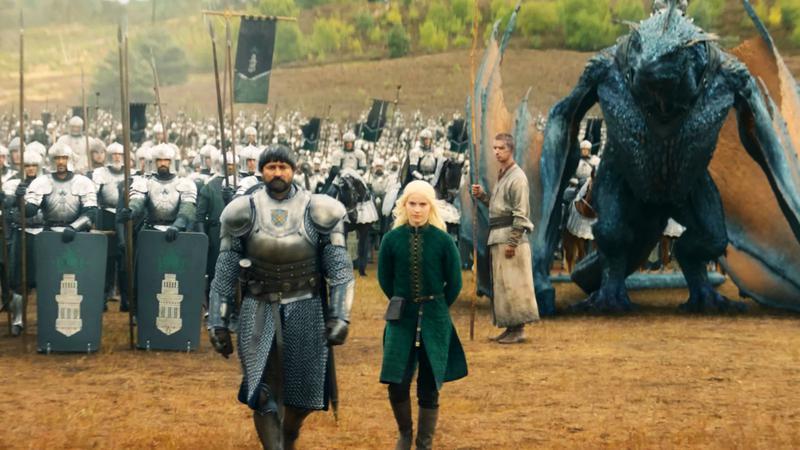 Daeron Targaryen walking with his dragon, Tessarion, and the Hightower army behind him.