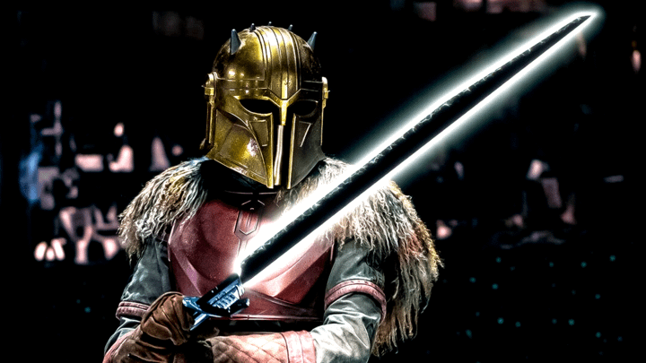 the Armorer holding the Darksaber.