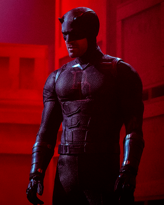 Charlie Cox as Daredevil in his all-black suit with red lighting.