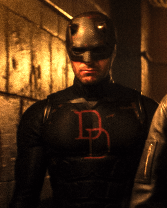 Charlie Cox as Daredevil in his black suit with red accents and red Ds.