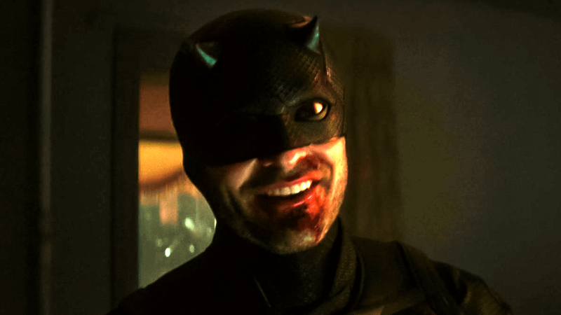 Charlie Cox Matt Murdock wears a sinister smile after taking a beating.