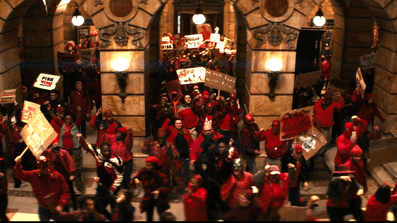 Crowd wearing red charging against Kingpin in Daredevil Born Again Season 2.