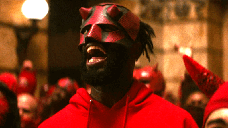 Man wearing Daredevil red and black mask rioting in Born Again Season 2 finale.