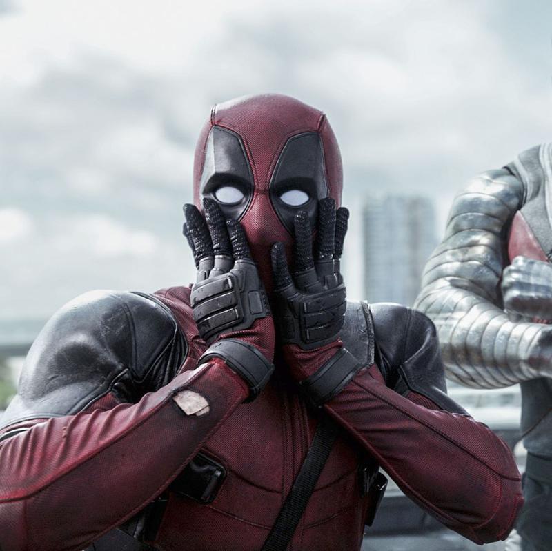 Ryan Reynolds as Deadpool holding his hands to his face in Deadpool