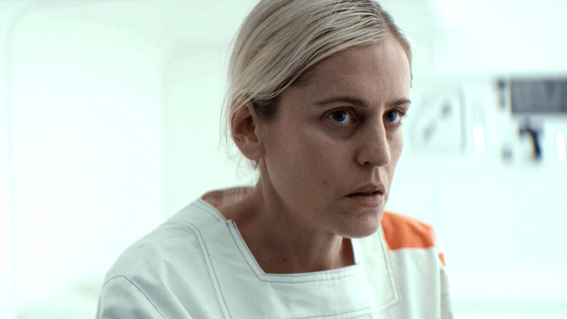 Denise Gough sitting in a white jail cell in Andor