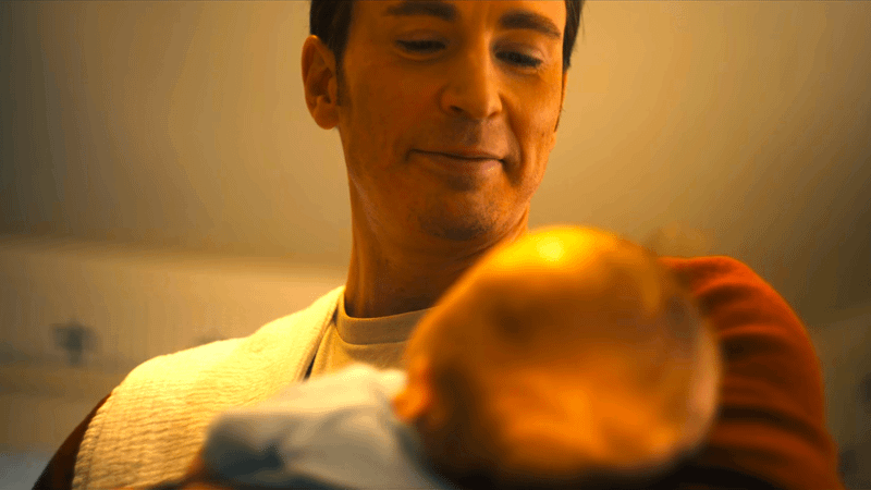 Chris Evans as Steve Rogers holding baby in Avengers: Doomsday.