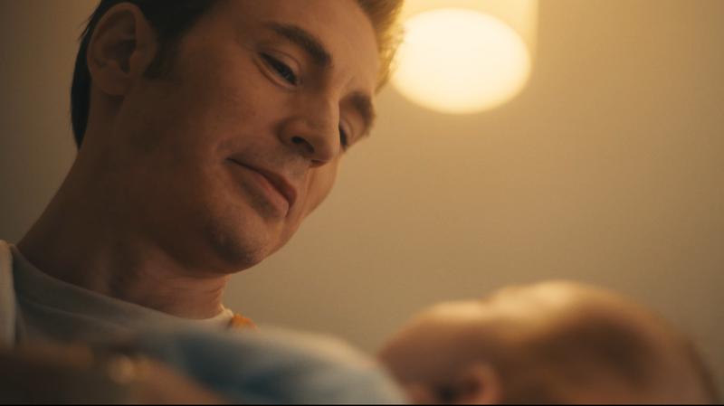 Chris Evans as Steve Rogers holding a baby in Avengers: Doomsday trailer