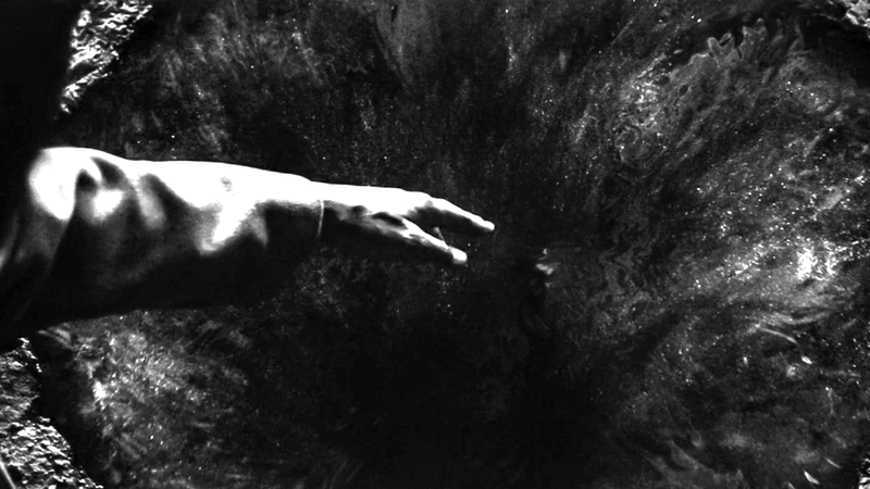 DeMarr Davis' hand reaches toward the puddle of black goo on the ground in Marvel Television's Wonder Man.