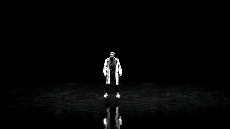 DeMarr Davis stands in the inky black Darkforce Dimension, his reflection on the floor, in Marvel Television's Wonder Man.