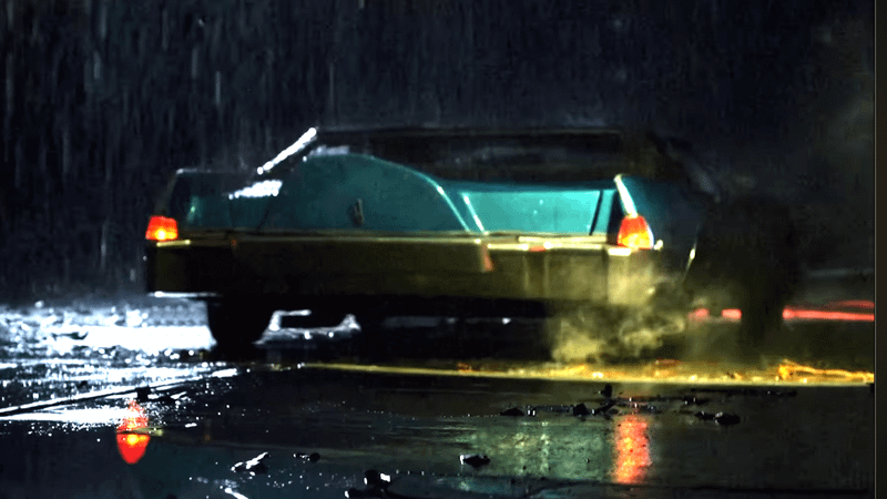 Rain soaked blue station wagon in Dynamic Duo clip.