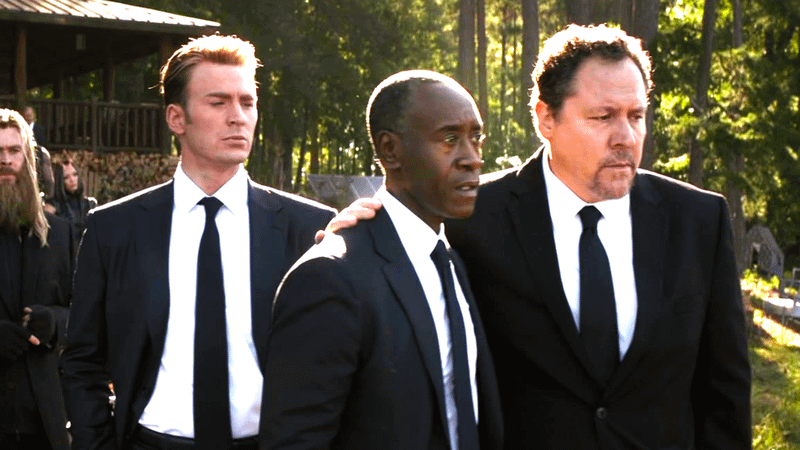 Chris Evans as Steve Rogers, Don Cheadle as James Rhodes, and Jon Favreau as Happy Hogan at Tony Stark's funeral in Avengers: Endgame.